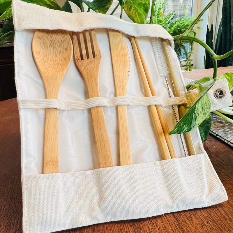 Set of bamboo cutlery including spoon, fork, and knives in a fabric pouch
