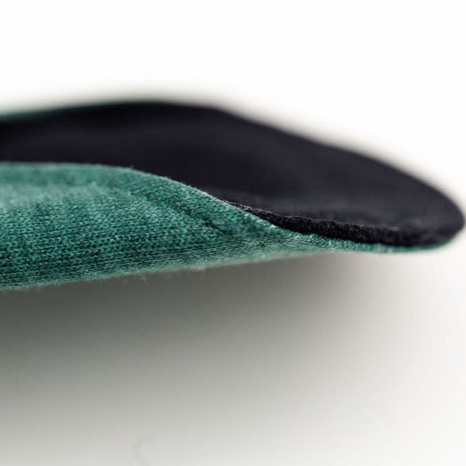 Close-up of reusable leakproof pad showcasing its thickness and material texture.