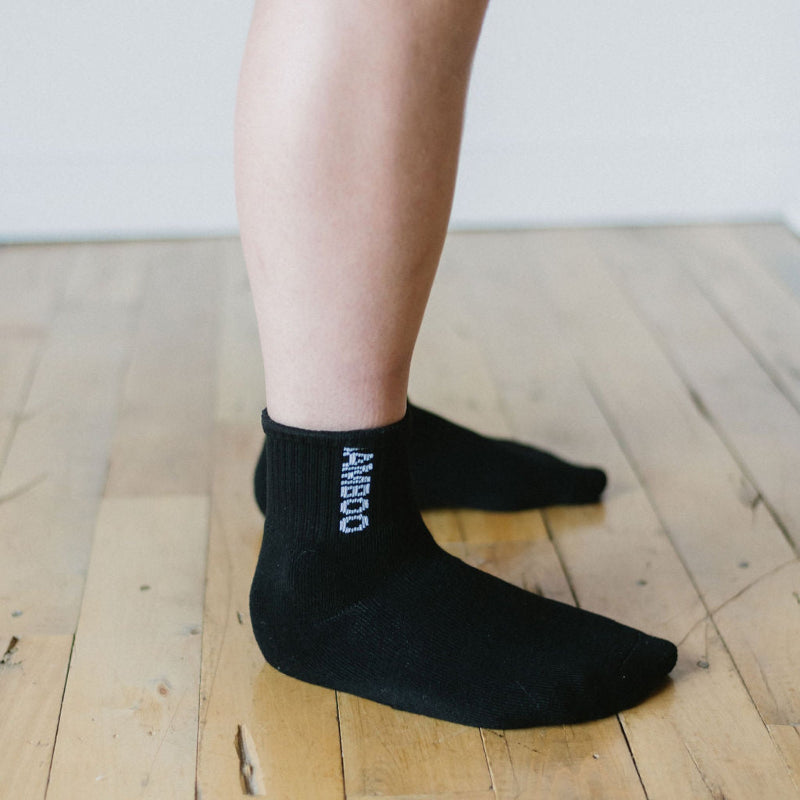 person wearing bamboo mid sport breathable socks in black 