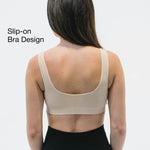 Woman wearing a beige slip-on bra with removable pads