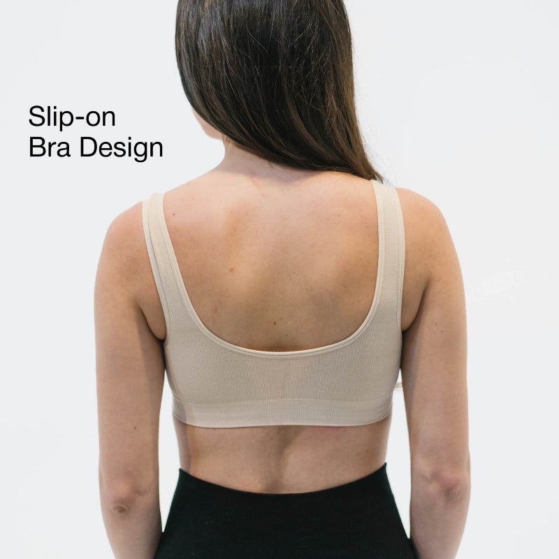 Woman wearing a beige slip-on bra with removable pads