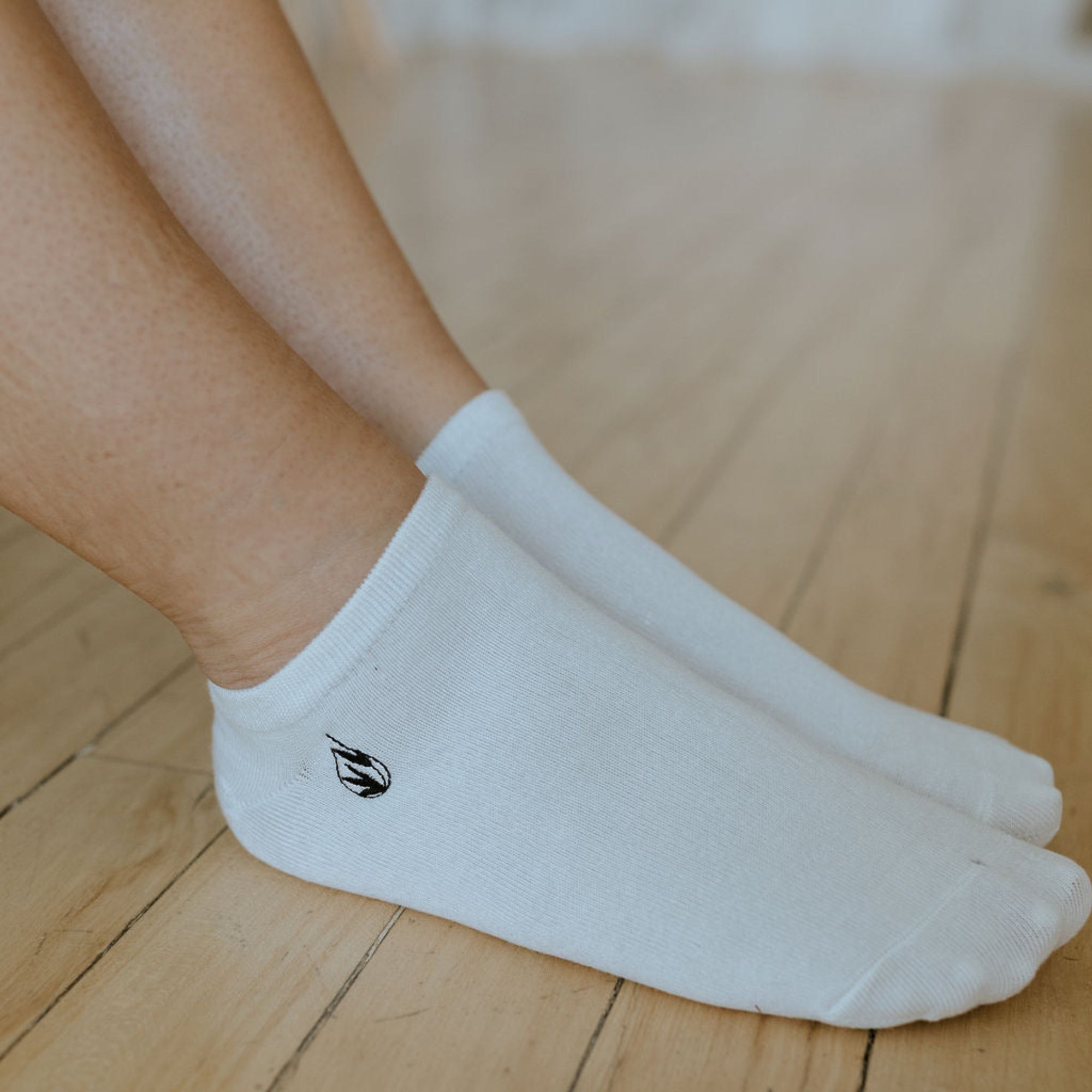 a pair of white everyday ankle socks being worn 