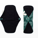 image displays the daytime reusable bamboo pad being unbuttoned and buttoned up 
