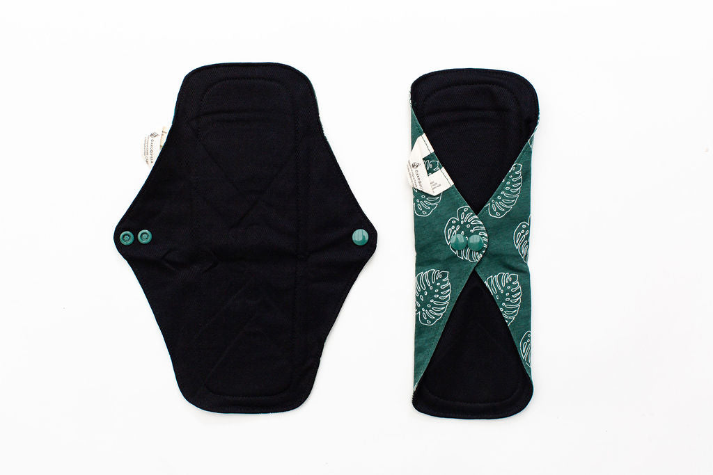 image displays the daytime reusable bamboo pad being unbuttoned and buttoned up 