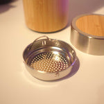 Metallic tea strainer with bamboo finish lid 