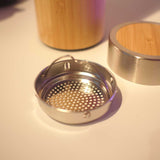 Metallic tea strainer with bamboo finish lid 