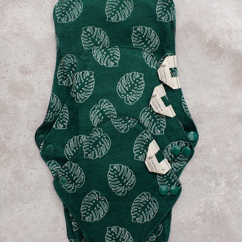 three bamboo reusable pads stacked on top of each other to show distinct sizes 