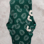 three bamboo reusable pads stacked on top of each other to show distinct sizes 