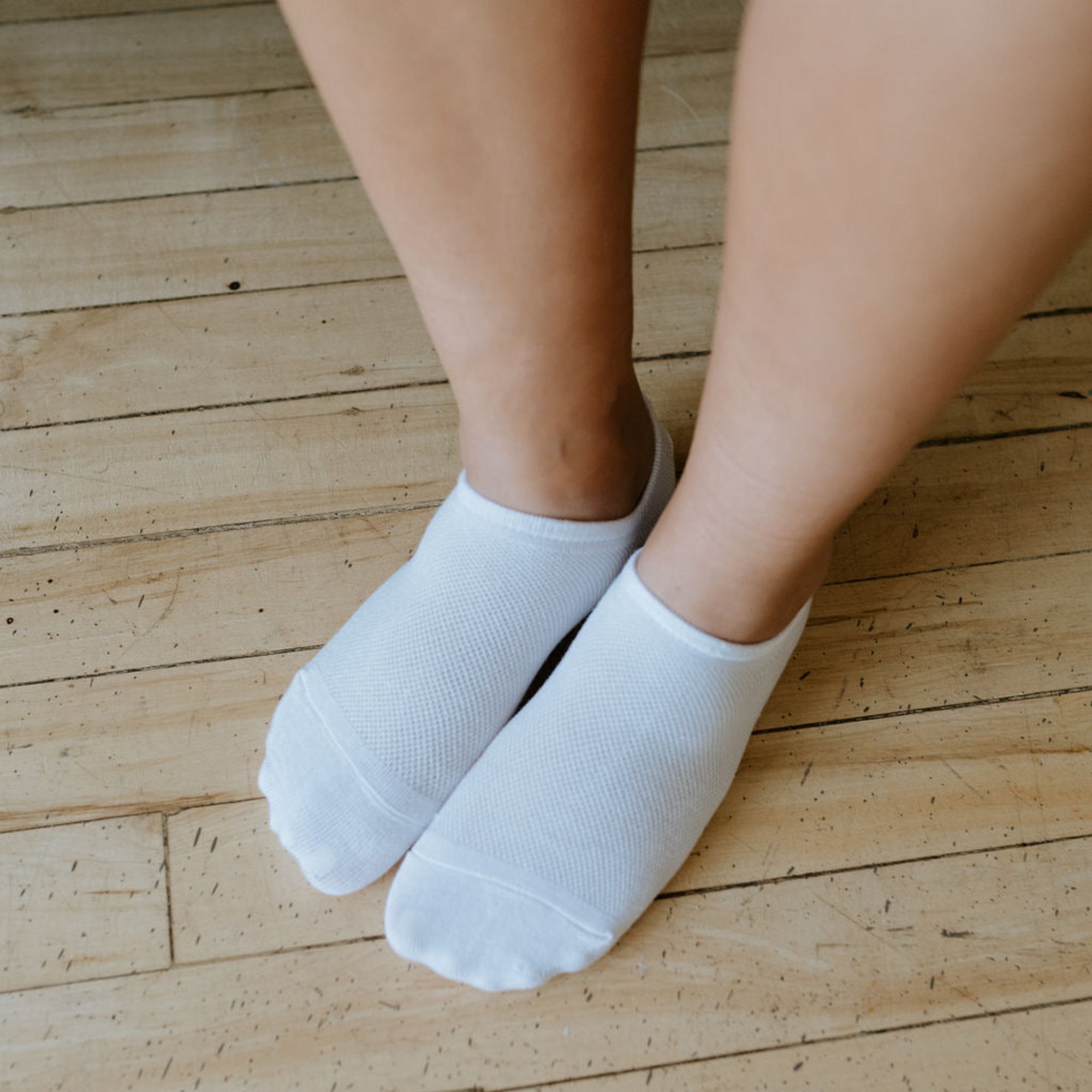 a pair of breathable bamboo no show sport socks being worn 